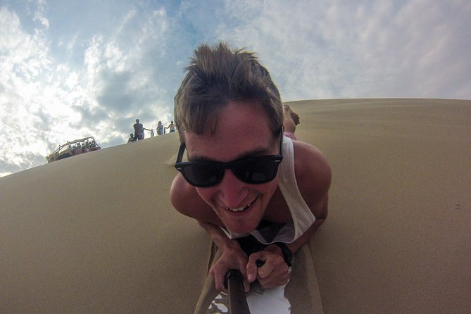 Dune buggy in Huacachina - Sandboarding from the top of a large dune
